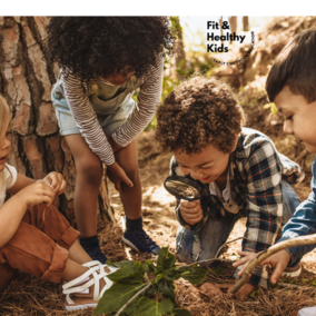 Children looking at leaves with a magnifying glass