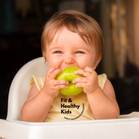 Toddler eating a green apple