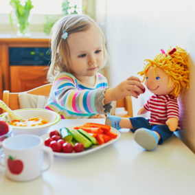 Girl feeding doll