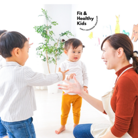 Teacher knelt down talking with three children