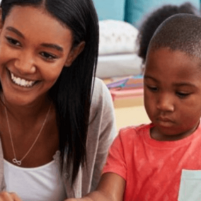 Child and teacher sit next to each other