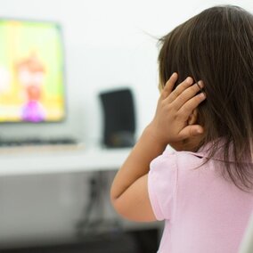 girl with hands on her ears