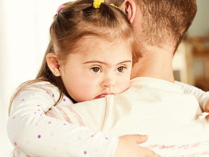 Little girl hugging her dad.