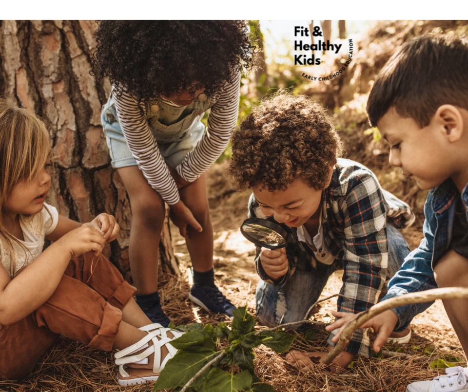Children looking at leaves with a magnifying glass