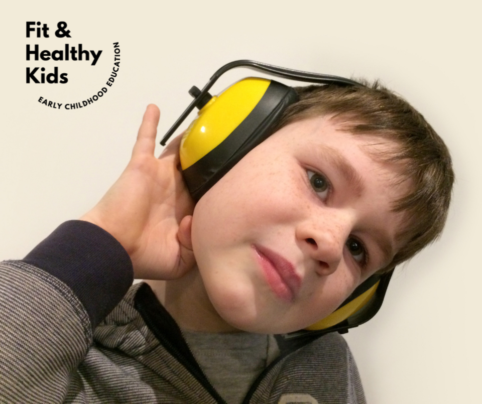 Young boy wearing yellow headphones