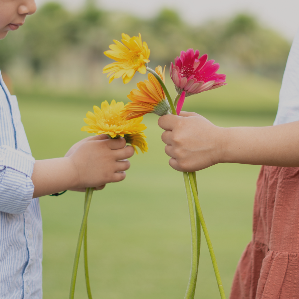 Two children holding flowers