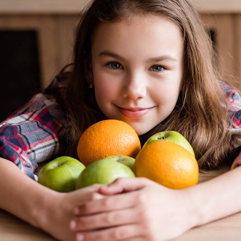 Girl holding fruit