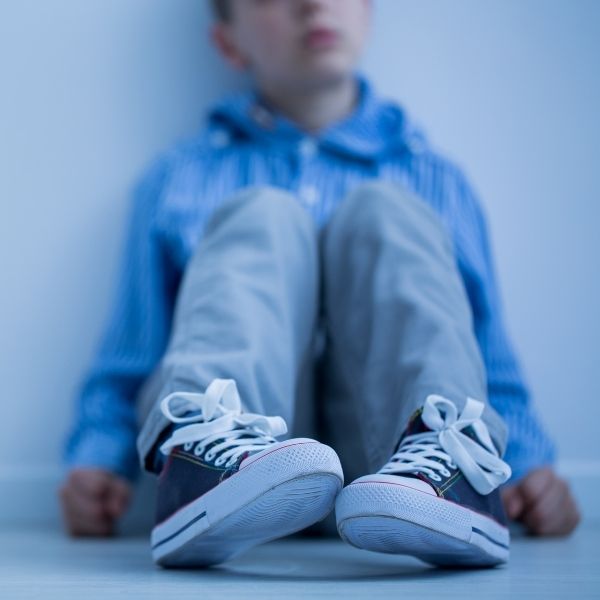 young boy sitting on the floor